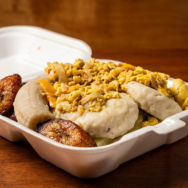 A takeout container filled with ackee and saltfish, fried dumplings, boiled banana, and plantains.